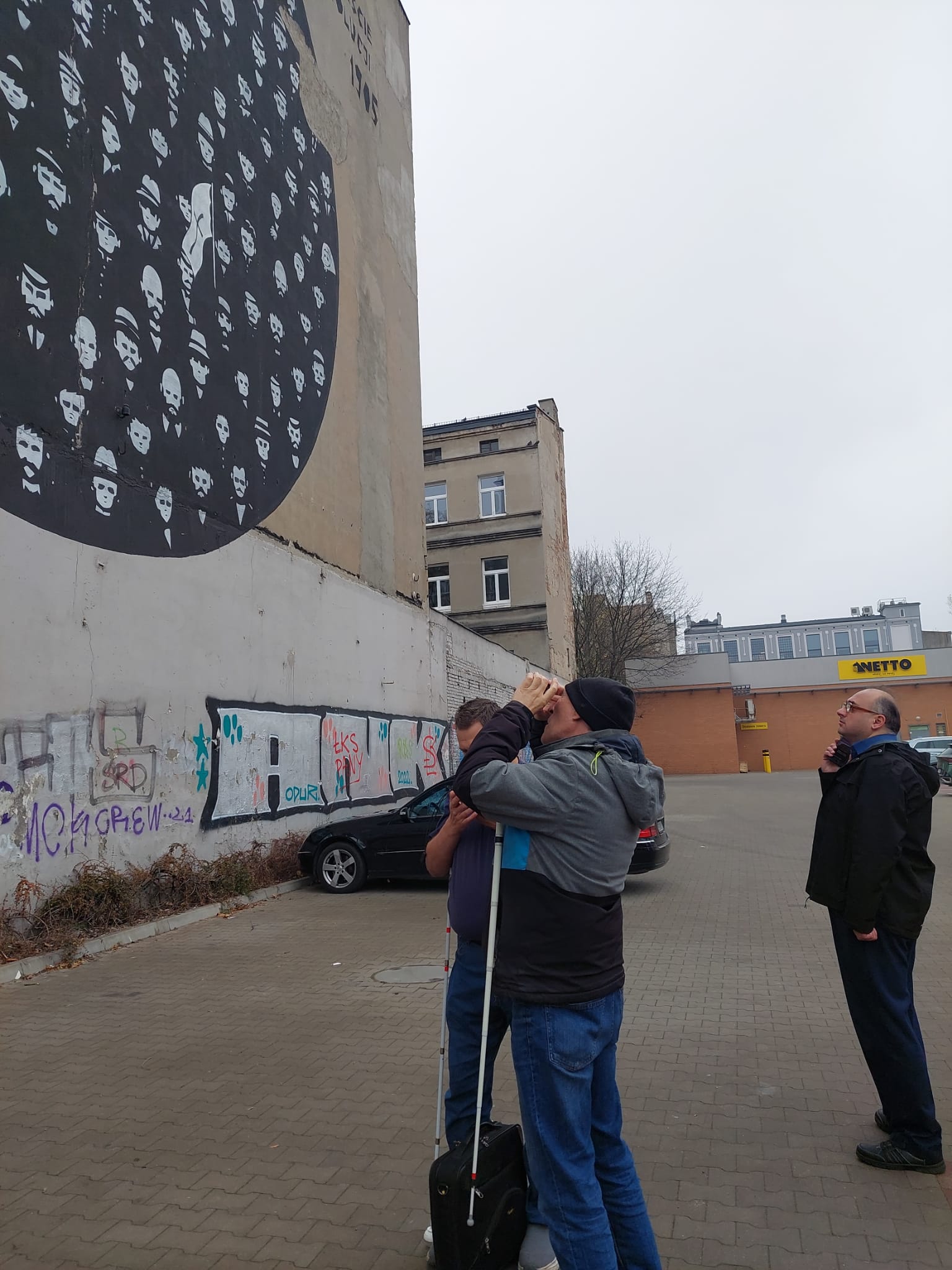 a visually impaired person viewing a mural by the use of a phone